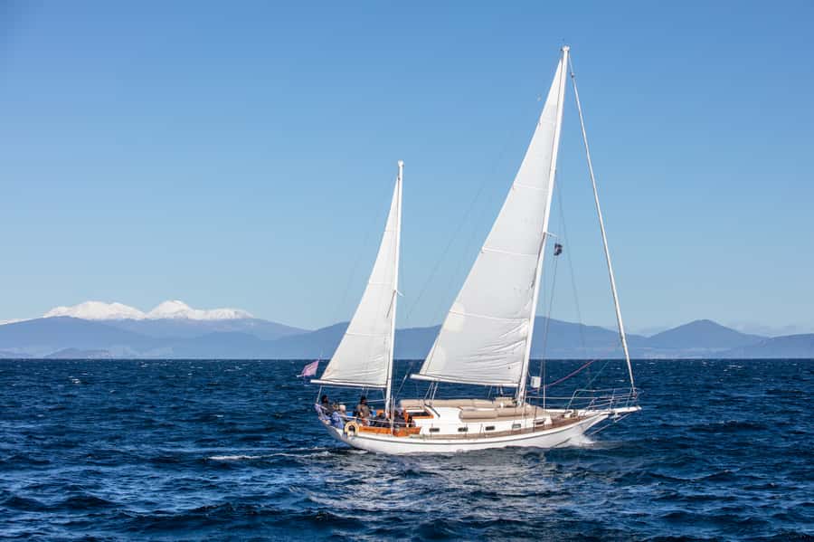Taupō: Sail Barbary Eco Sailing to the Maori Rock Carvings - Sailing past volcanic shores and changing bays